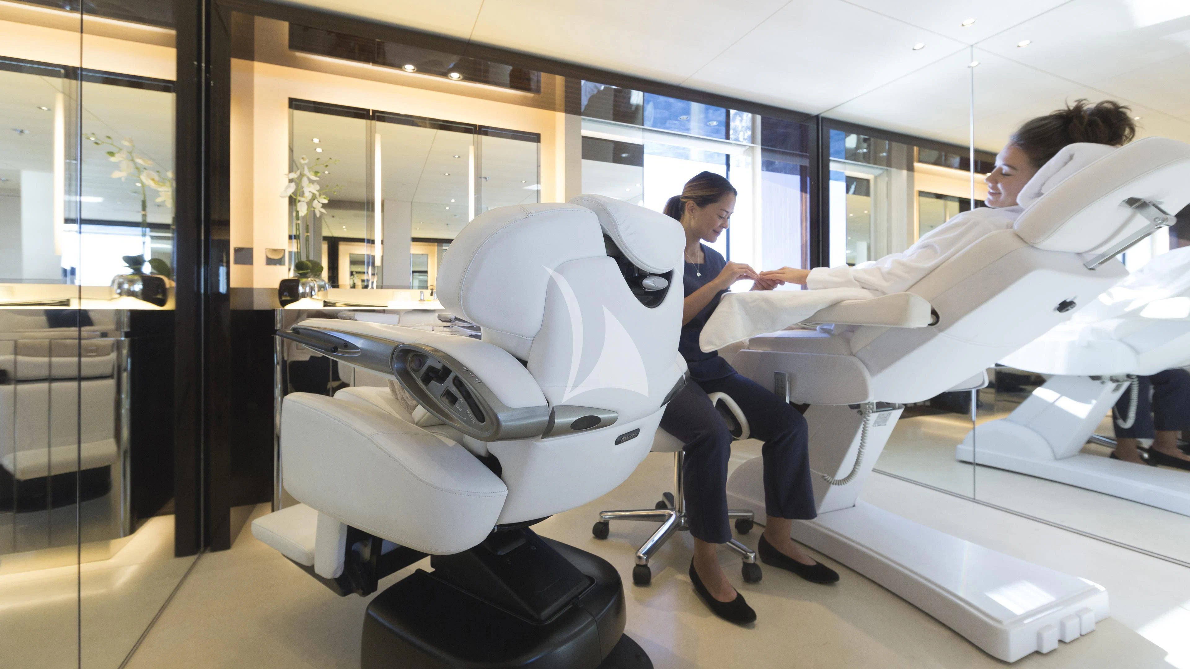 a person in a white lab coat working on a white machine aboard NAUTILUS Yacht for Sale