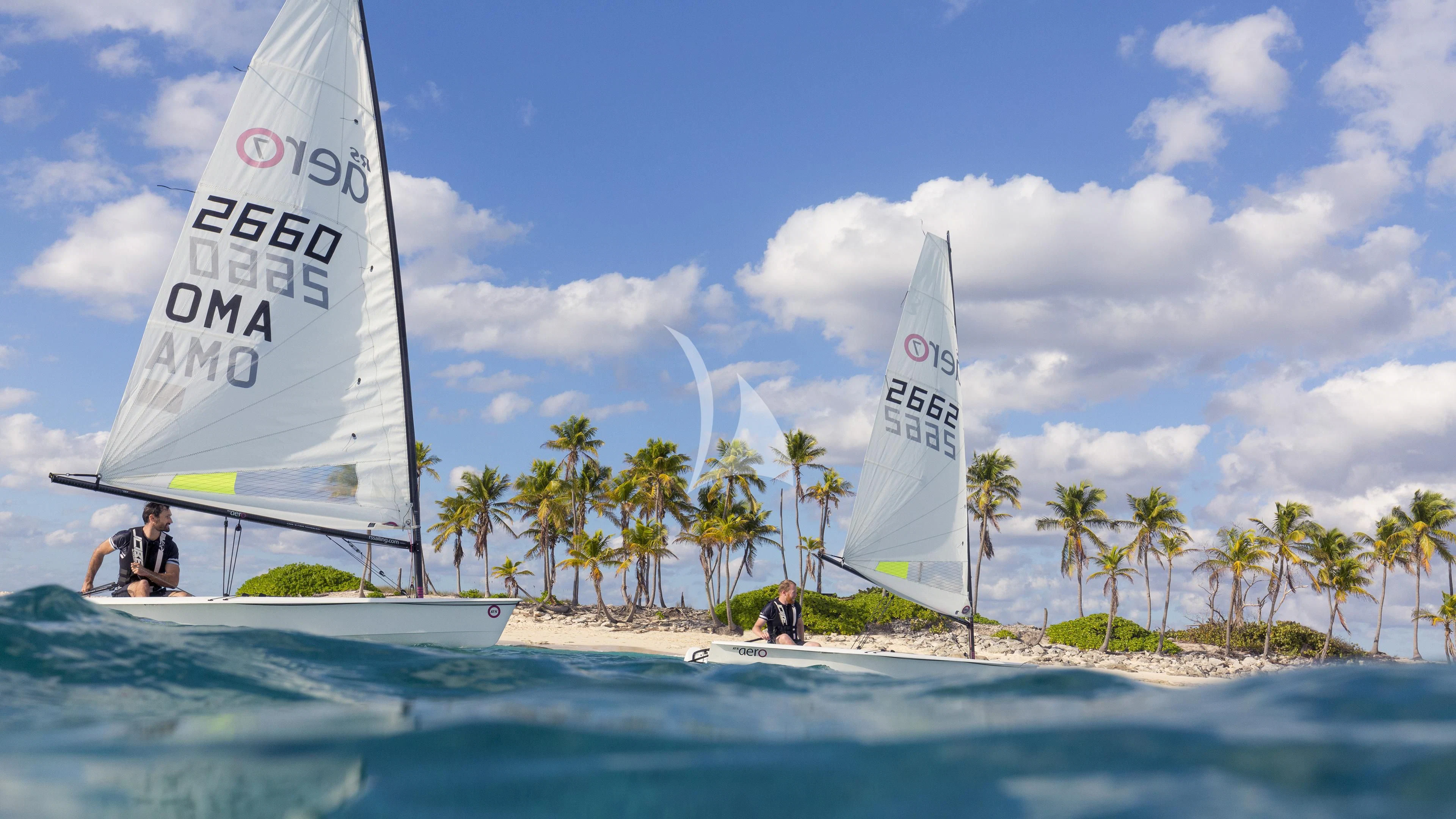 a person on a surfboard next to a sailboat aboard NAUTILUS Yacht for Sale