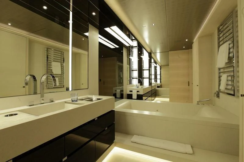 a bathroom with a bathtub and sinks aboard NAUTILUS Yacht for Sale