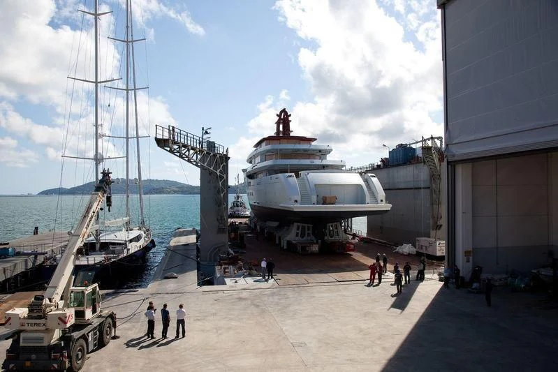 a group of people walking on a sidewalk next to a large ship aboard NAUTILUS Yacht for Sale
