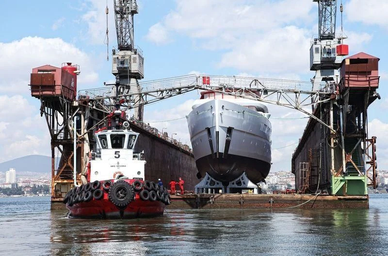 a large boat with a large ship on it aboard NAUTILUS Yacht for Sale