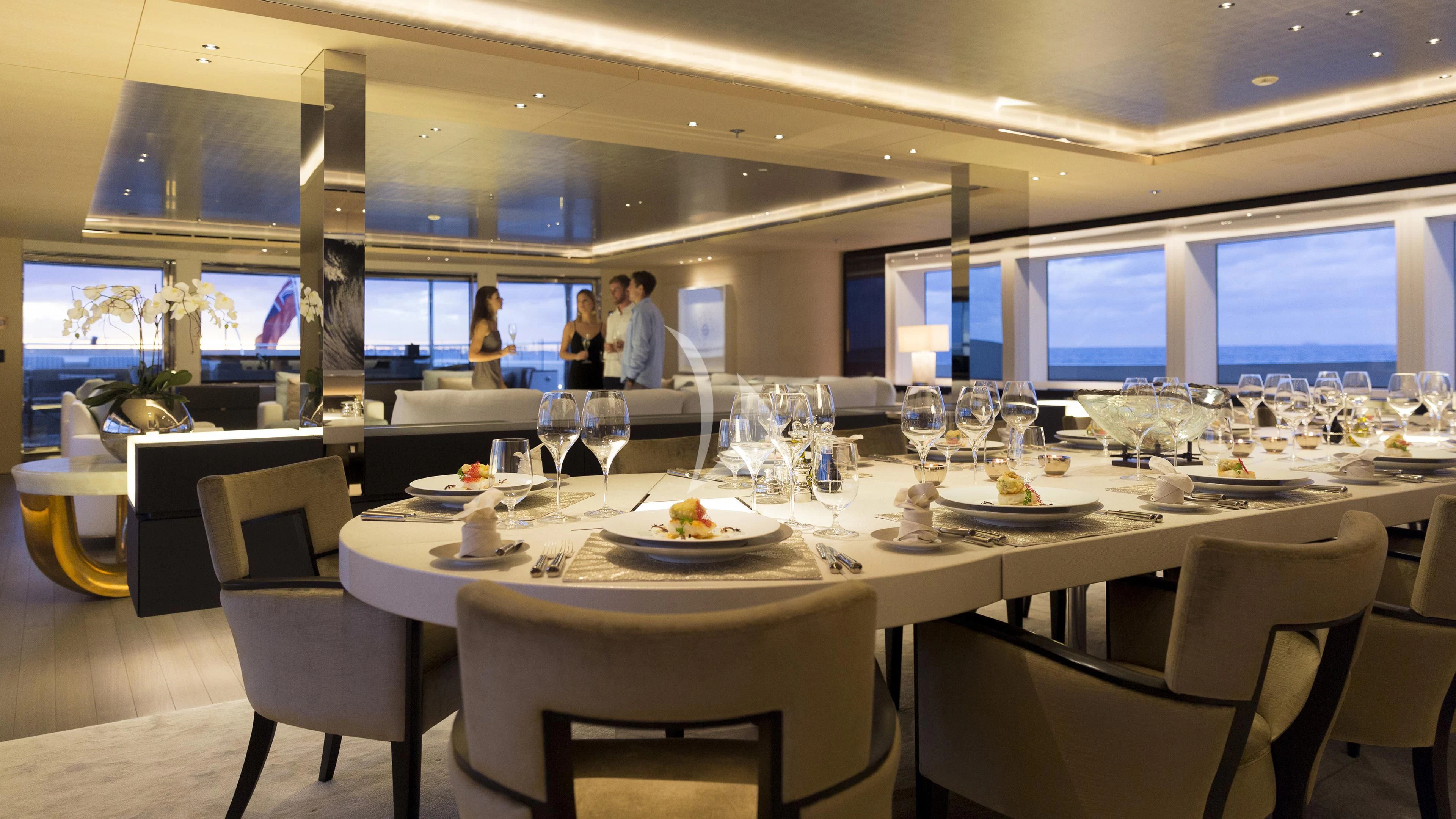 a group of people sitting at a table with wine glasses and food aboard NAUTILUS Yacht for Sale
