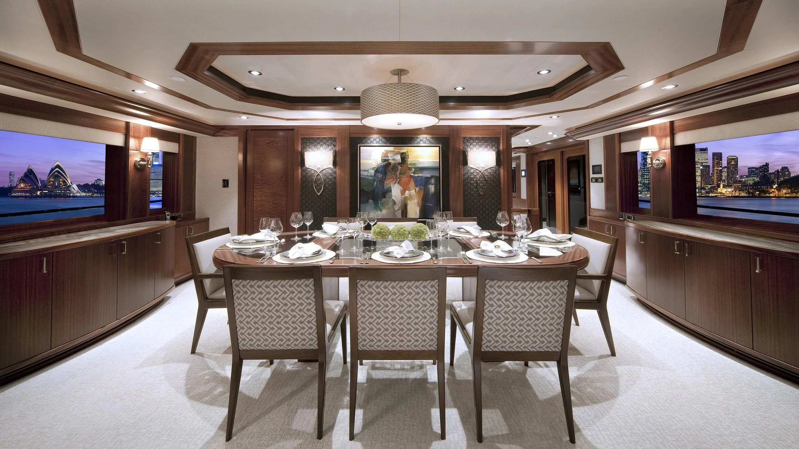 a large dining table in a large room with a large television aboard WESTPORT 130 #4016 Yacht for Sale