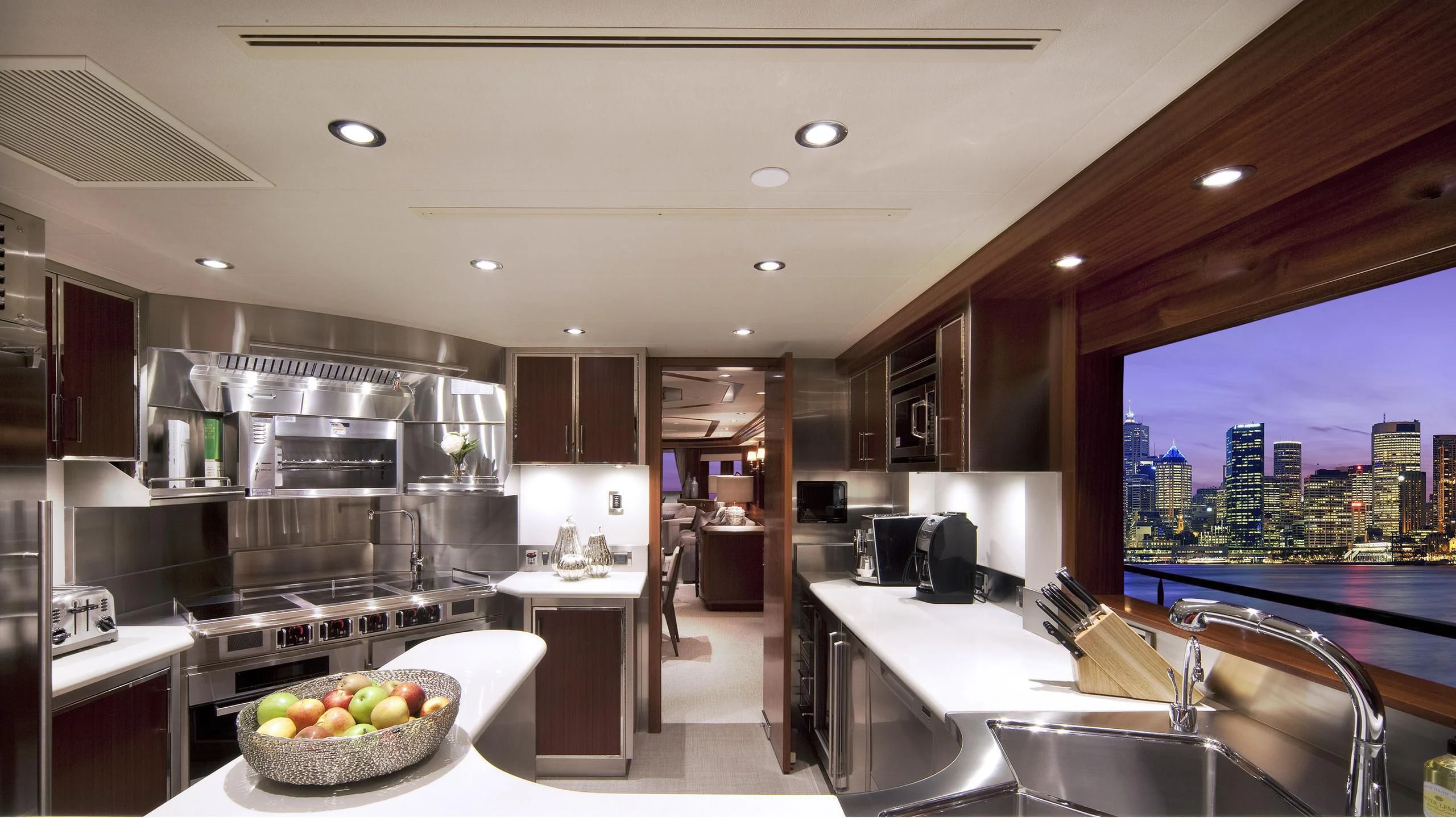 a kitchen with a bowl of fruit aboard WESTPORT 130 #4016 Yacht for Sale