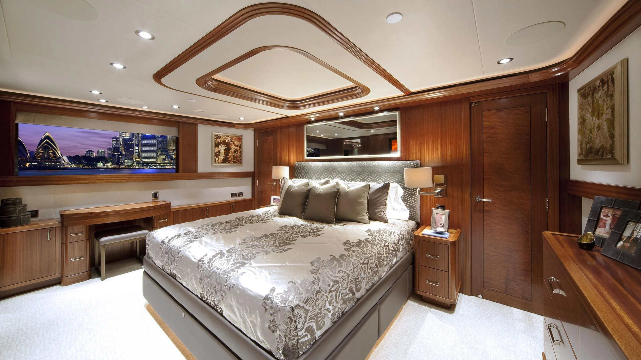 a bedroom with a bed and a desk aboard WESTPORT 130 #4016 Yacht for Sale