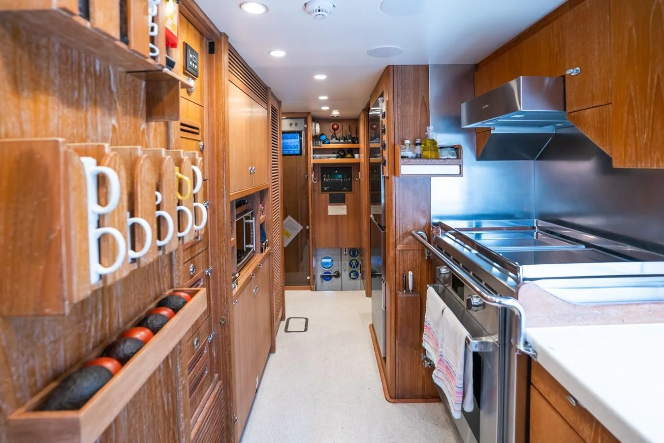 a kitchen with wooden cabinets aboard LA CATTIVA 1 Yacht for Sale
