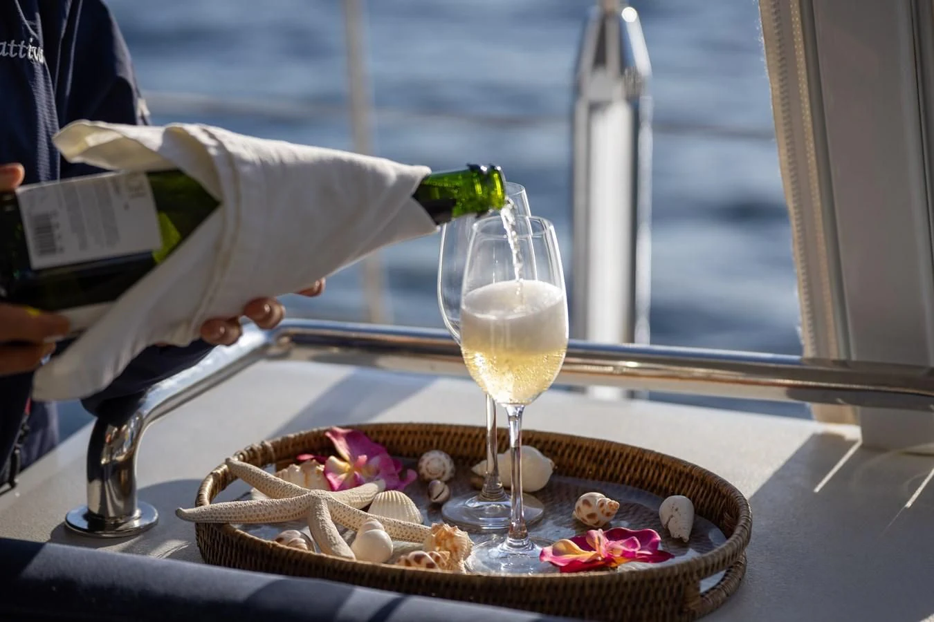 a person pouring a glass of wine aboard LA CATTIVA 1 Yacht for Sale