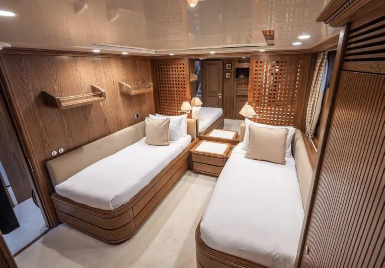 a room with a couple of beds aboard LA CATTIVA 1 Yacht for Sale