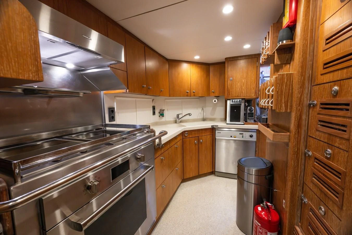 a kitchen with wooden cabinets aboard LA CATTIVA 1 Yacht for Sale