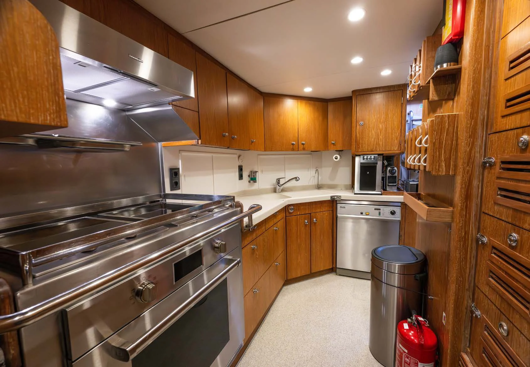 a kitchen with wooden cabinets aboard LA CATTIVA 1 Yacht for Sale