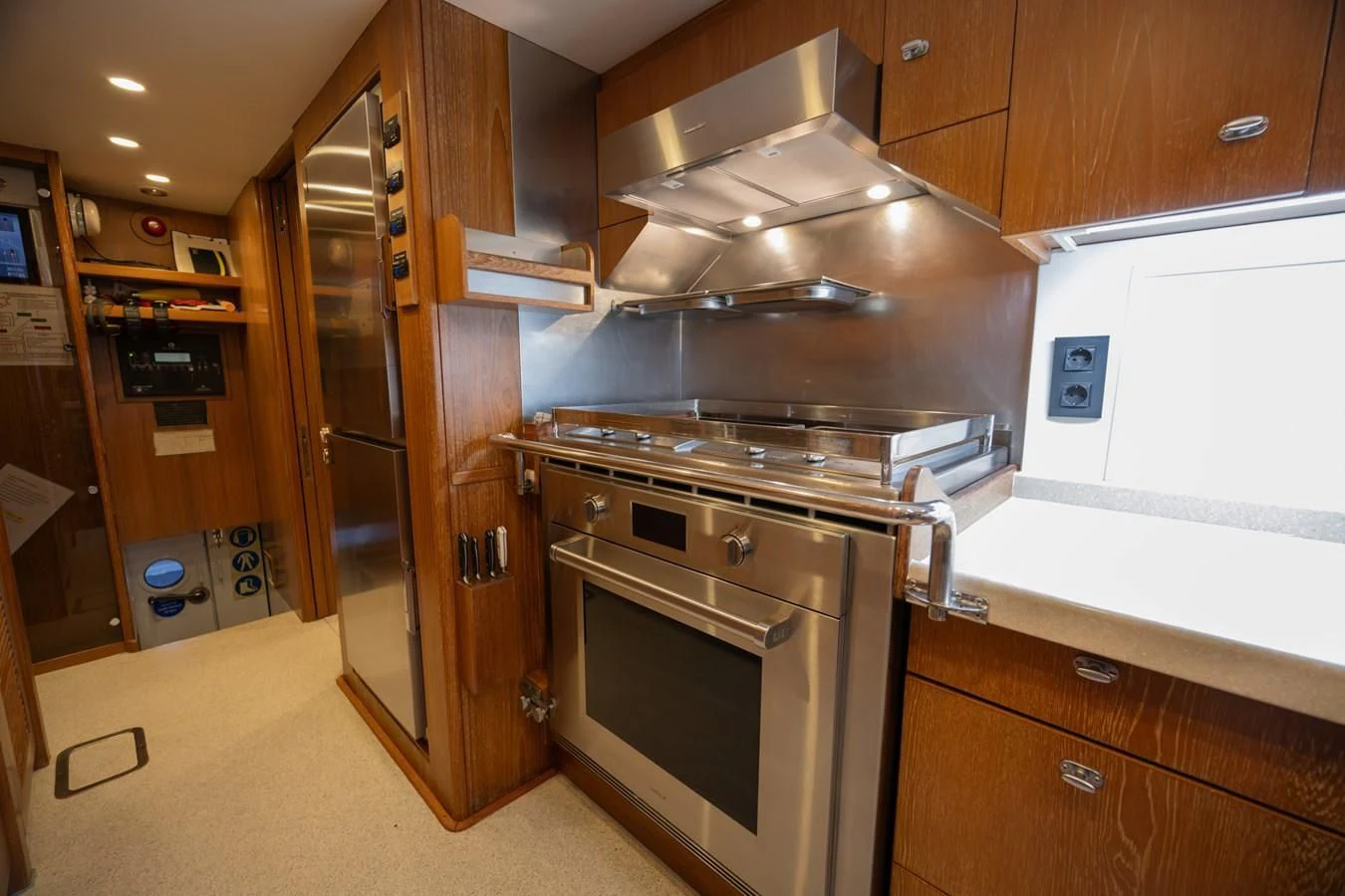 a kitchen with wooden cabinets aboard LA CATTIVA 1 Yacht for Sale
