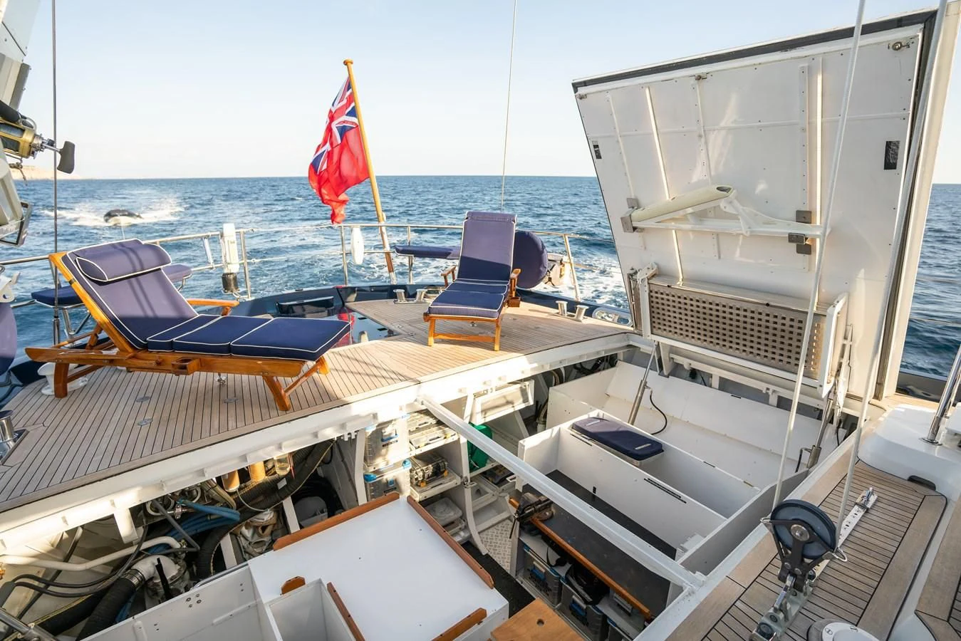 a boat with a flag on the deck aboard LA CATTIVA 1 Yacht for Sale