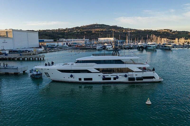 a large white boat in a harbor aboard JOANNA B Yacht for Sale