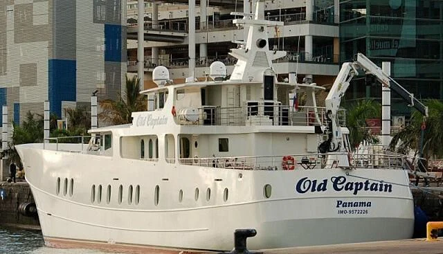 a white boat in a harbor aboard GALATEA Yacht for Sale