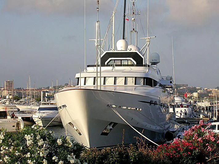 a large white boat in a harbor aboard IL VAGABONDO Yacht for Sale