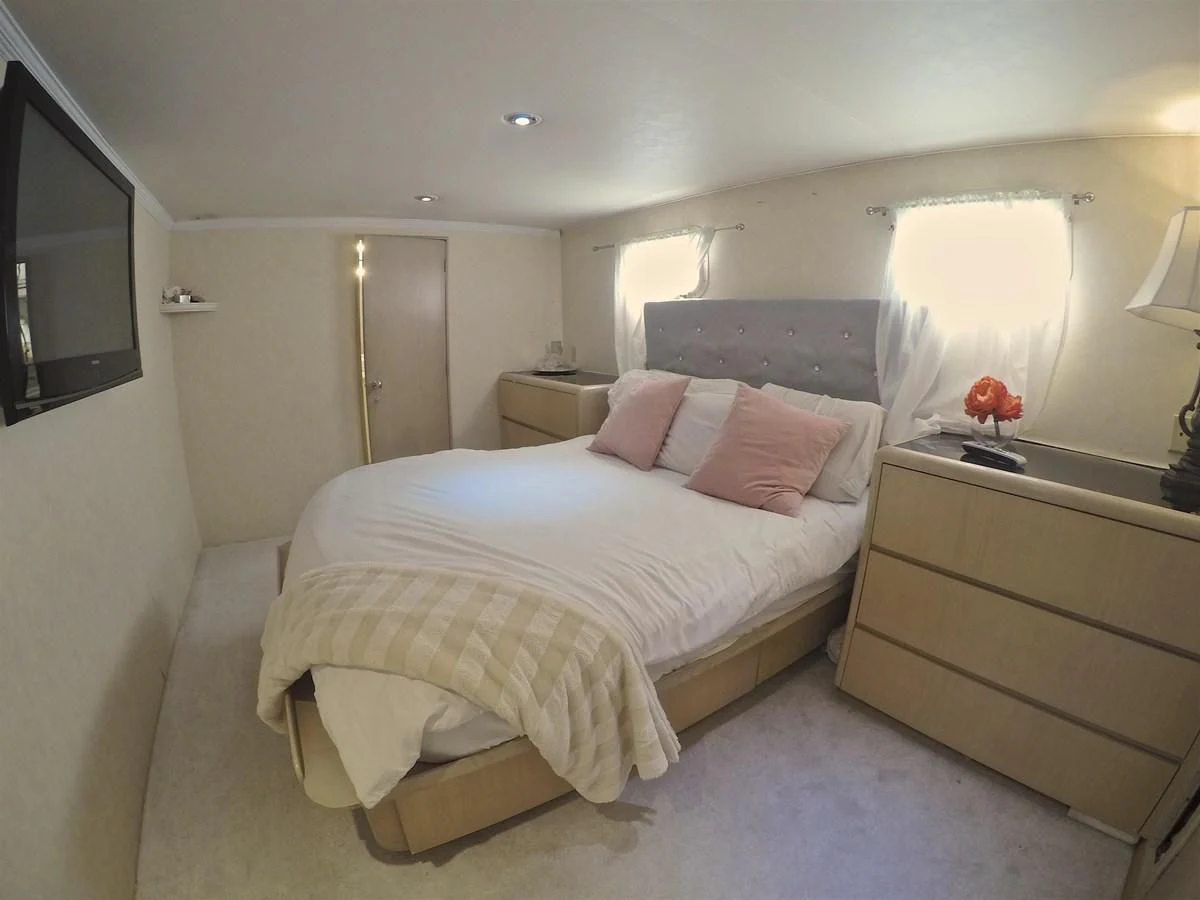 a bedroom with a bed and a mirror aboard ISABELLA Yacht for Sale