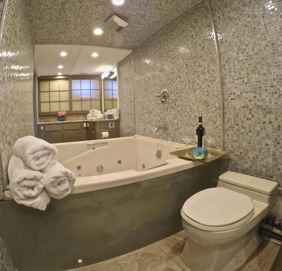 a bathroom with a tub toilet and sink aboard ISABELLA Yacht for Sale