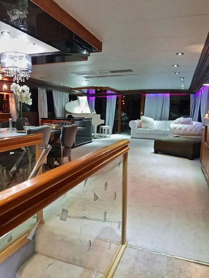 a room with a table and couches aboard ISABELLA Yacht for Sale