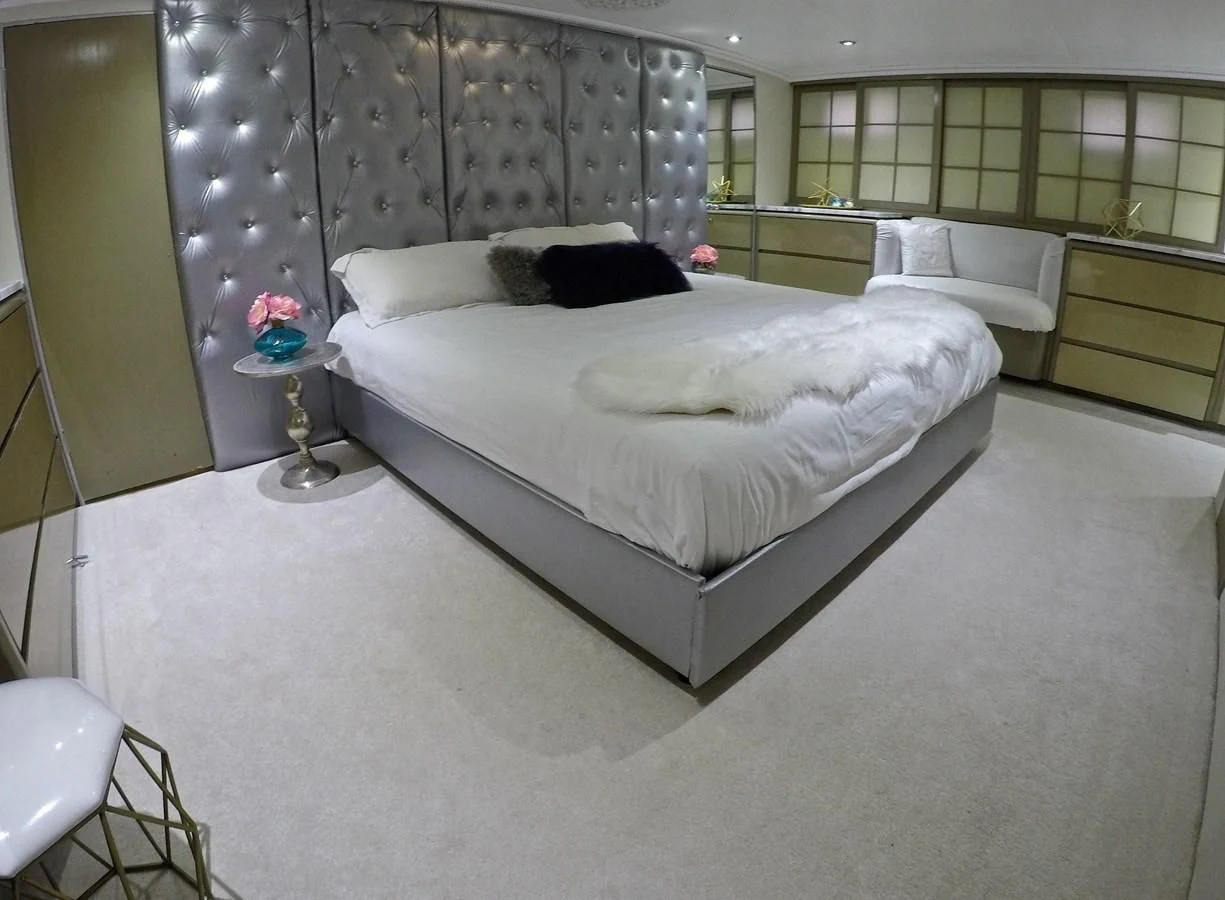 a bedroom with a bed and a window aboard ISABELLA Yacht for Sale