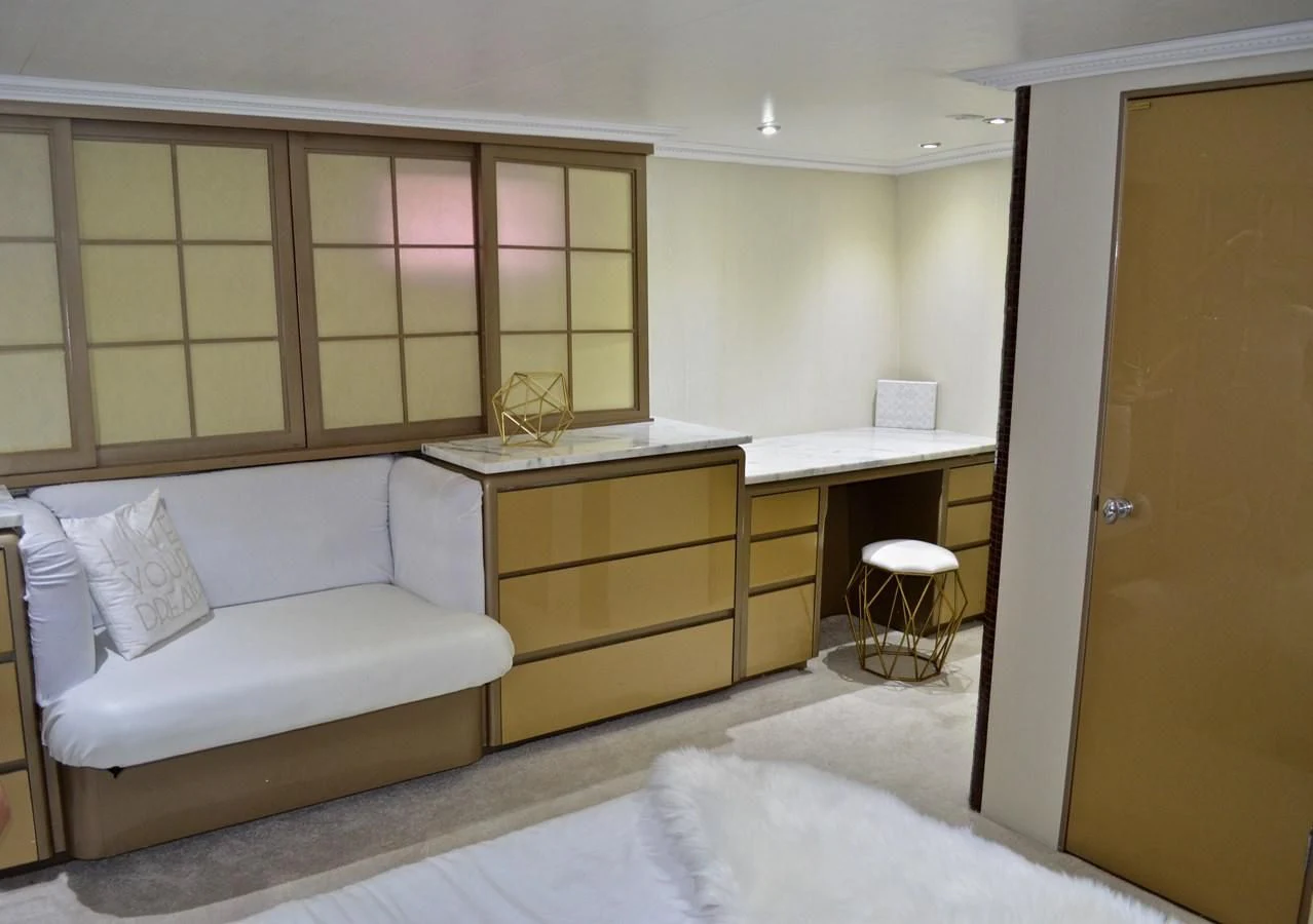 a room with a bed and desk aboard ISABELLA Yacht for Sale