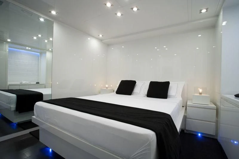 a bedroom with a bed and a couch aboard FRISH Yacht for Sale