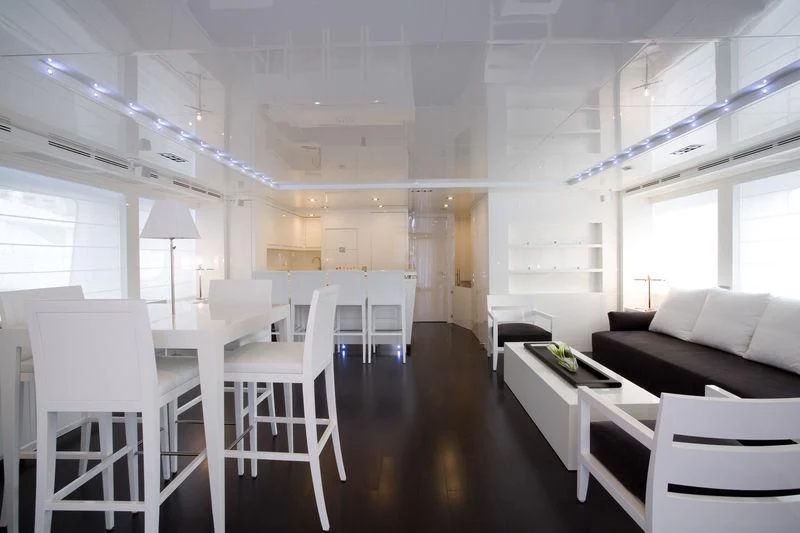 a room with white chairs and a table aboard FRISH Yacht for Sale