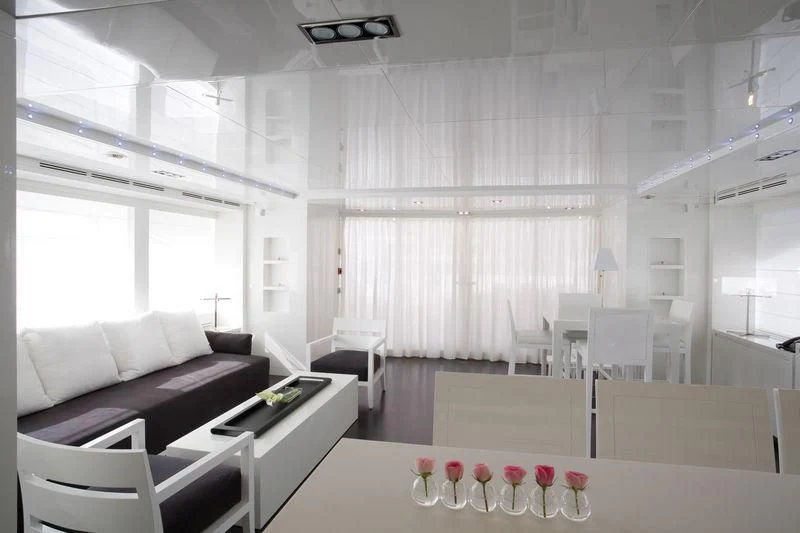 a room with white furniture aboard FRISH Yacht for Sale