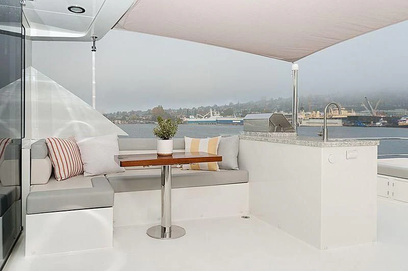 a room with a table and couches aboard VARIABLE Yacht for Sale