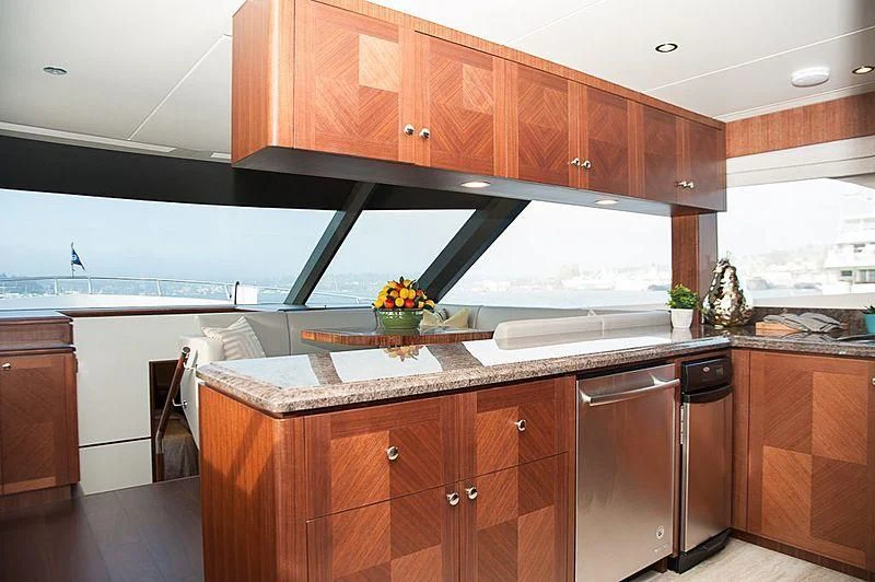a kitchen with wooden cabinets aboard VARIABLE Yacht for Sale