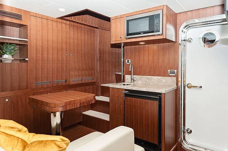 a kitchen with wooden cabinets aboard VARIABLE Yacht for Sale