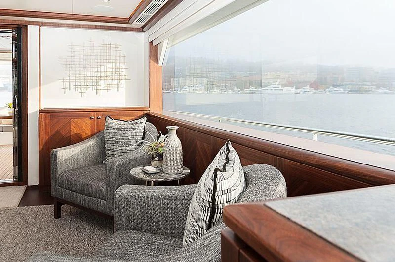 a couch and a table in a room with a window aboard VARIABLE Yacht for Sale