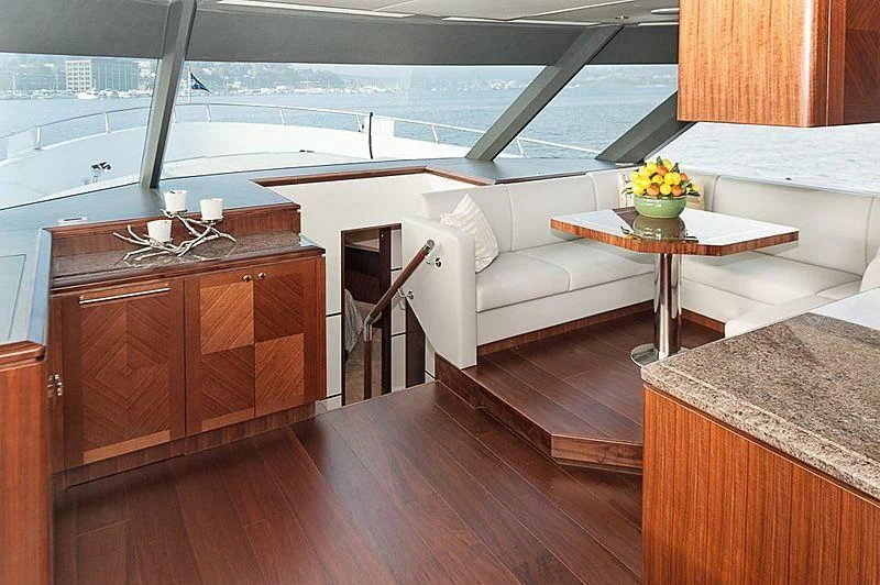 a living room with a table and couch aboard VARIABLE Yacht for Sale
