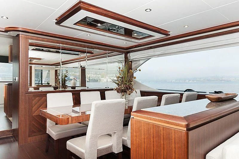 a room with a table chairs and a plant in it aboard VARIABLE Yacht for Sale