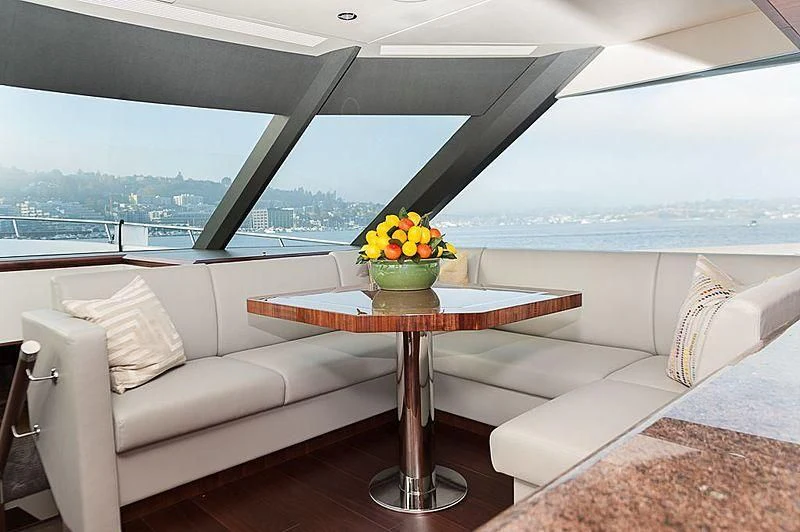 a living room with a table and a couch aboard VARIABLE Yacht for Sale