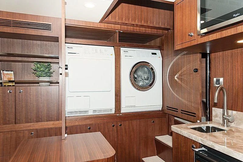 a kitchen with wooden cabinets aboard VARIABLE Yacht for Sale