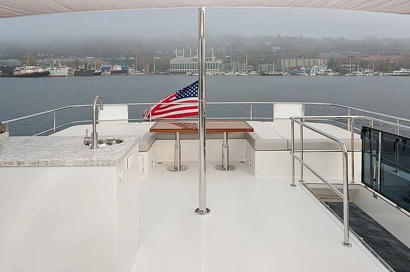 a flag on a railing overlooking a body of water aboard VARIABLE Yacht for Sale