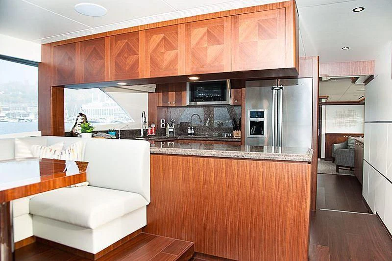 a kitchen with wooden cabinets aboard VARIABLE Yacht for Sale