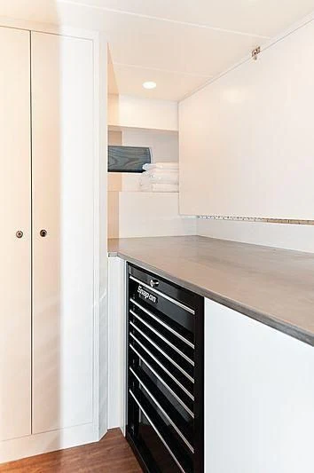 a kitchen with a black stove aboard VARIABLE Yacht for Sale