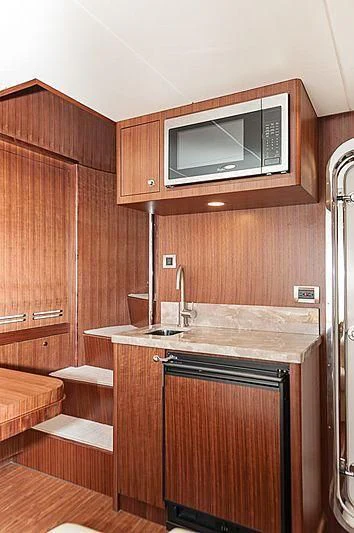 a kitchen with wooden cabinets aboard VARIABLE Yacht for Sale