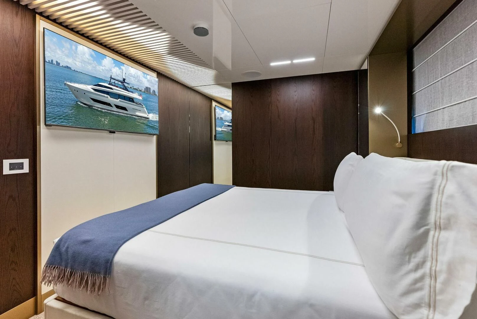 a bed with a picture on the wall aboard INEA Yacht for Sale