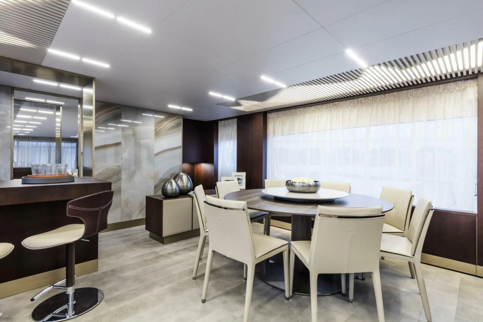 a room with tables and chairs aboard INEA Yacht for Sale