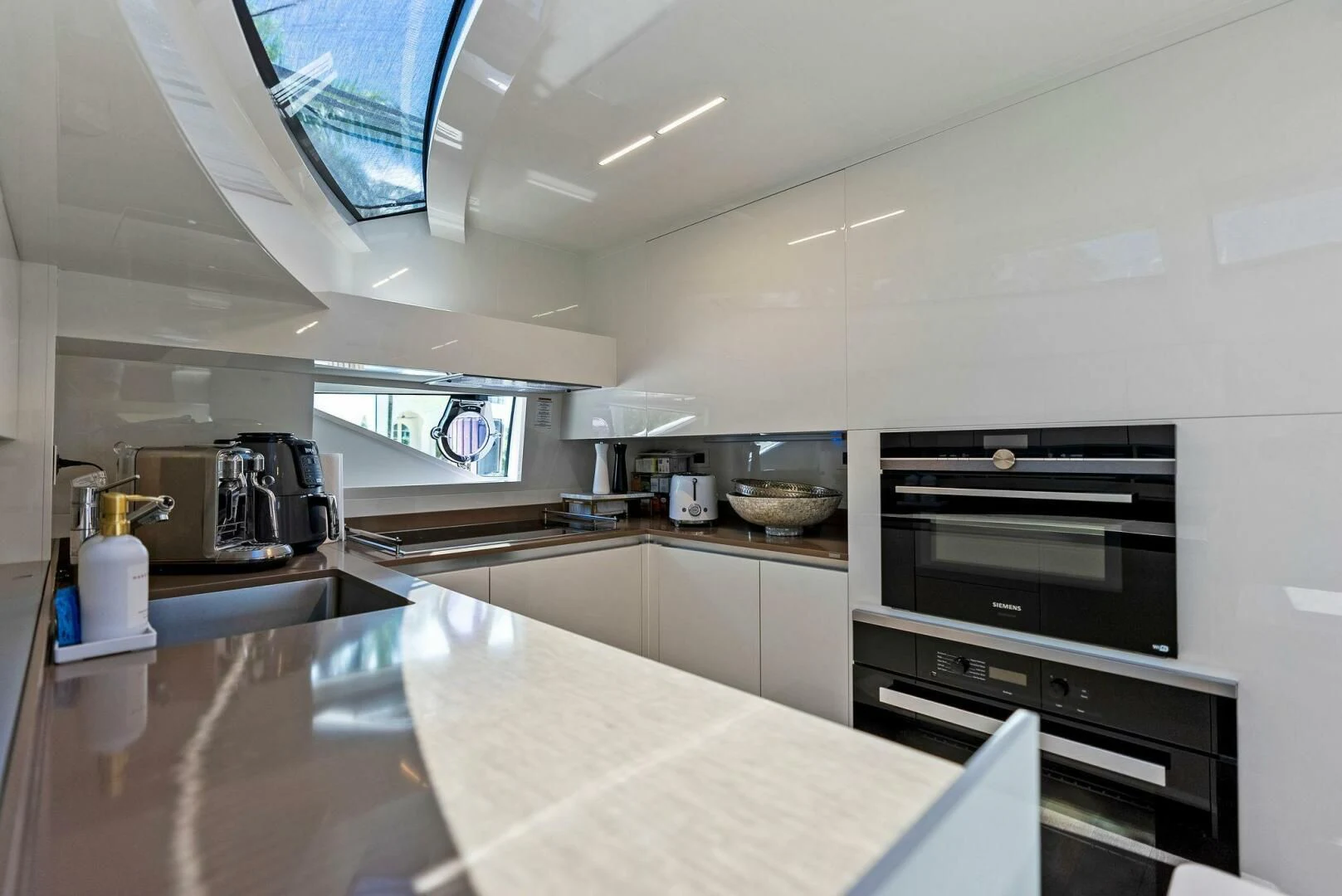a kitchen with a large island aboard INEA Yacht for Sale