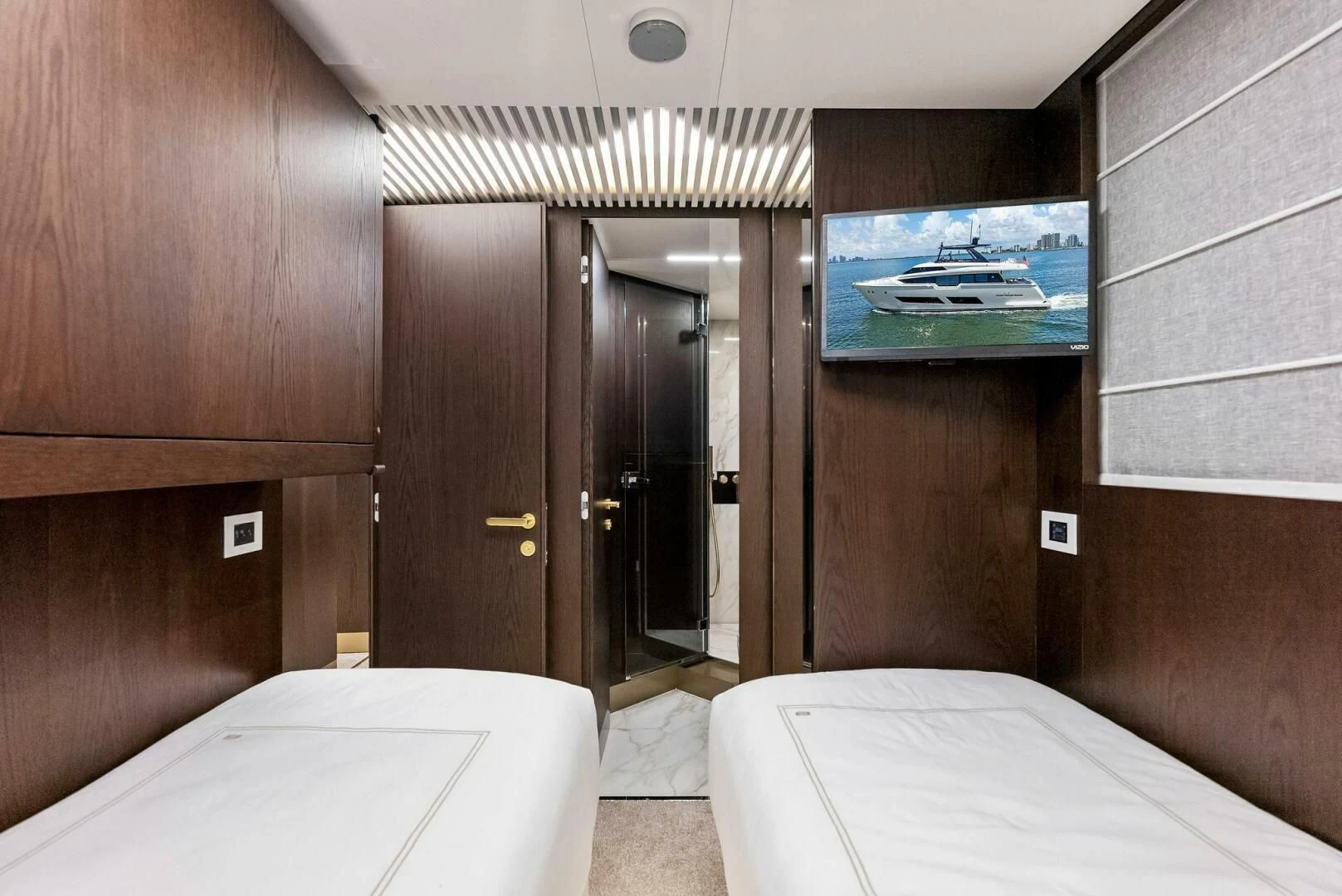 a hotel room with a bed and a television aboard INEA Yacht for Sale