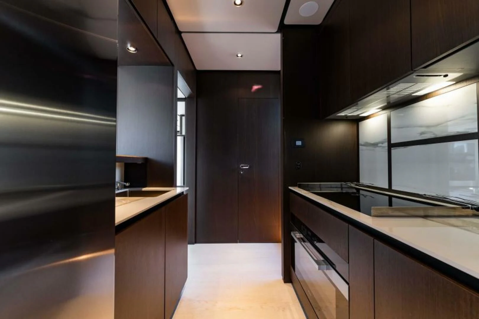 a kitchen with black cabinets aboard INEA Yacht for Sale