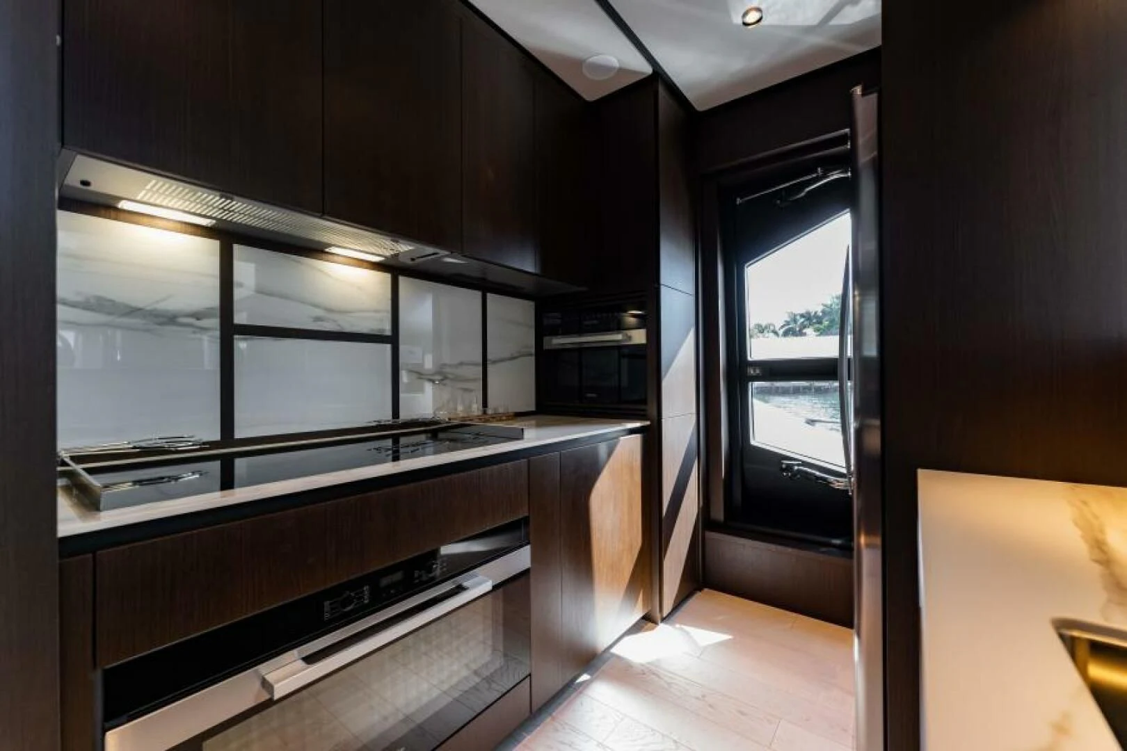 a kitchen with black cabinets aboard INEA Yacht for Sale