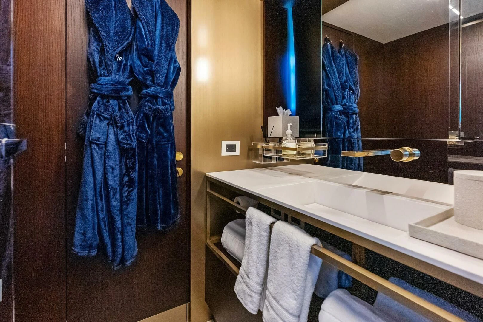 a bathroom with a blue shower curtain aboard INEA Yacht for Sale