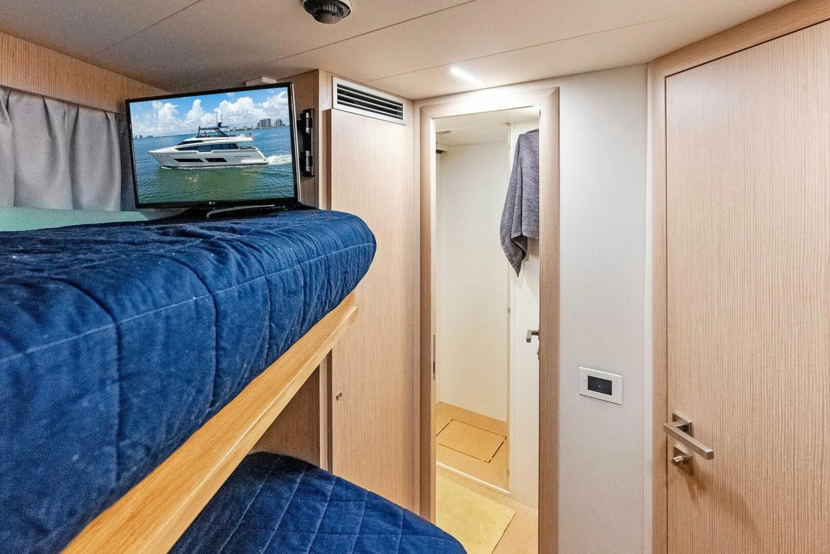 a bedroom with a blue bed aboard INEA Yacht for Sale
