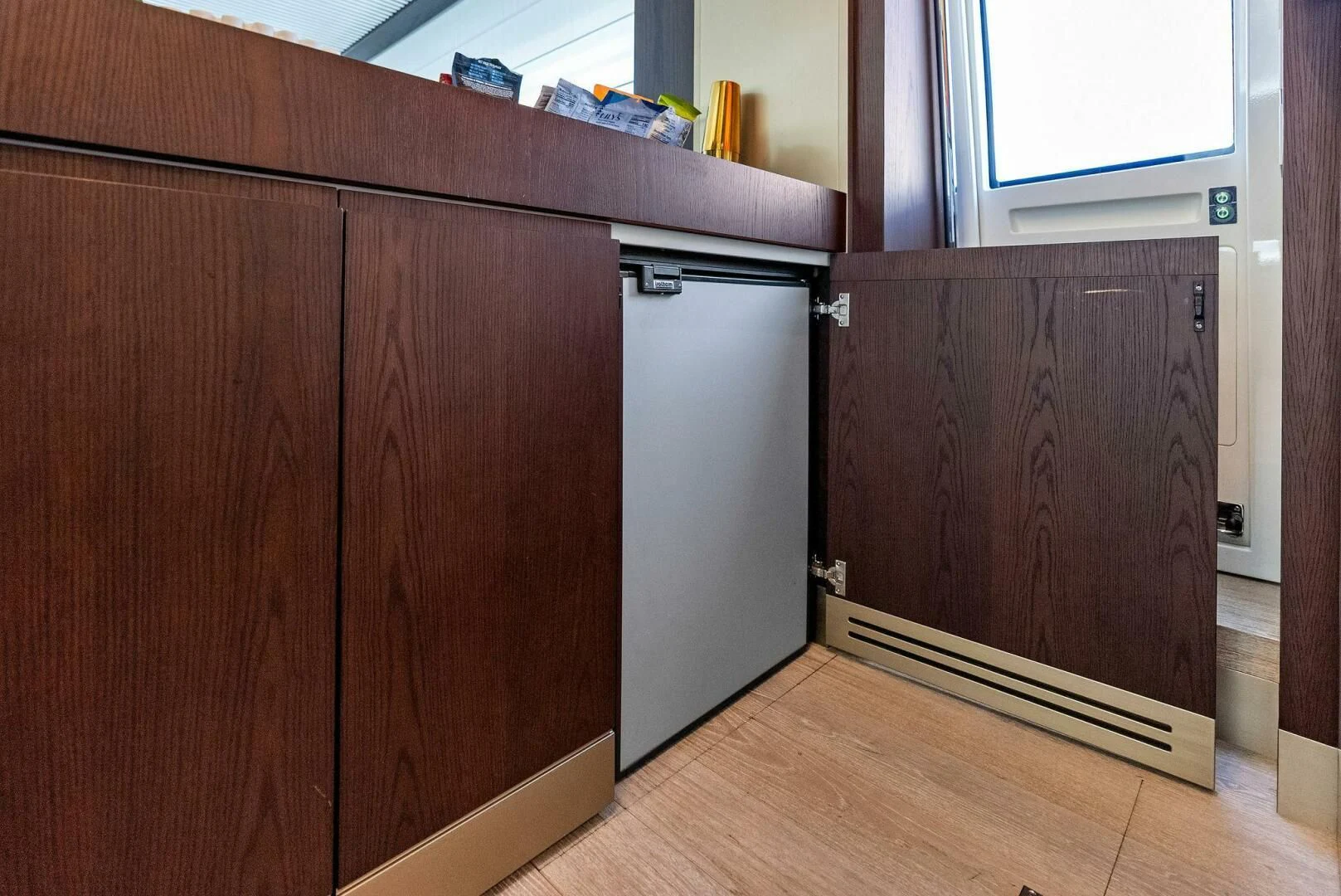 a kitchen with wooden cabinets aboard INEA Yacht for Sale