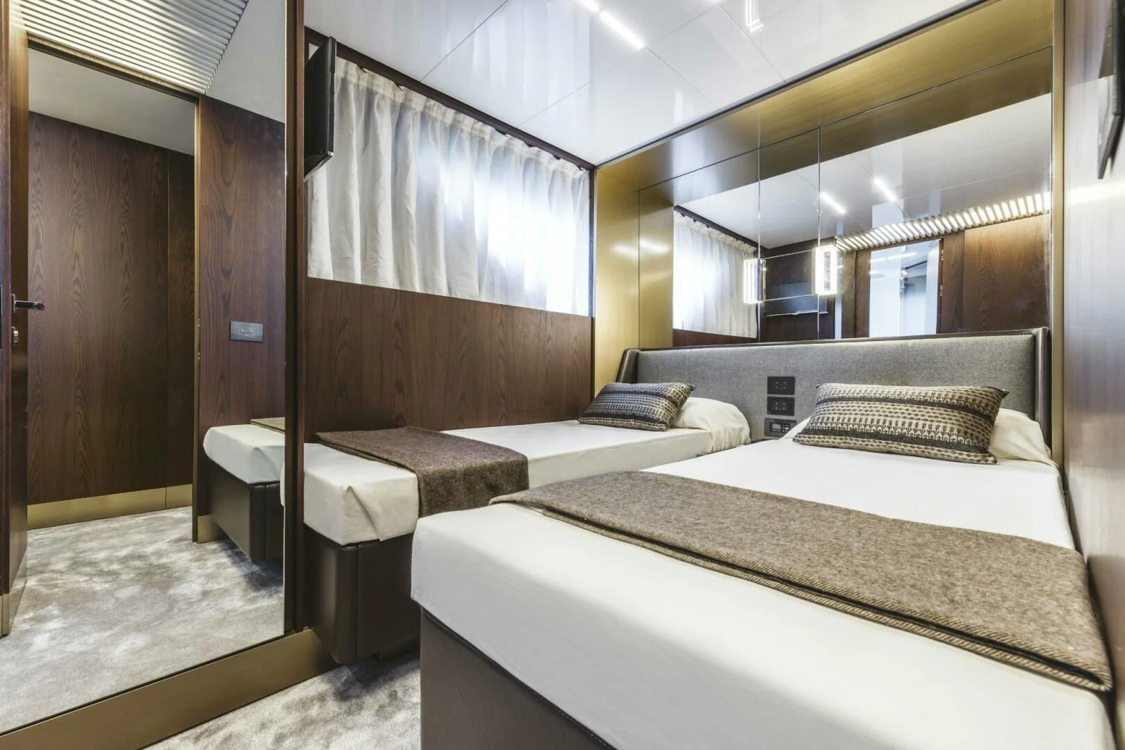 a room with beds and a mirror aboard INEA Yacht for Sale