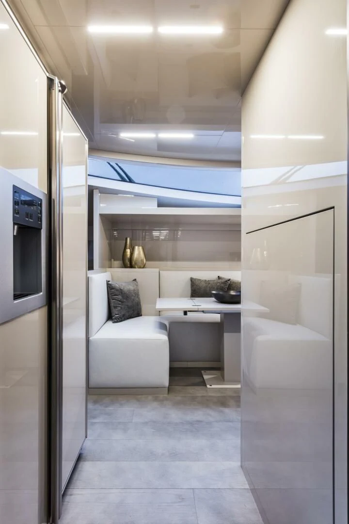 a modern looking room with a white couch and a large mirror aboard INEA Yacht for Sale